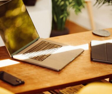 A laptop computer sitting on top of a wooden desk